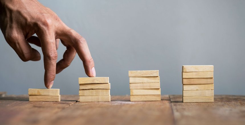 Hand liken business person jump a toy staircase to success, business concept