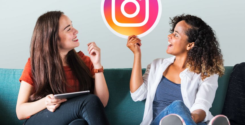 Young women showing an Instagram icon